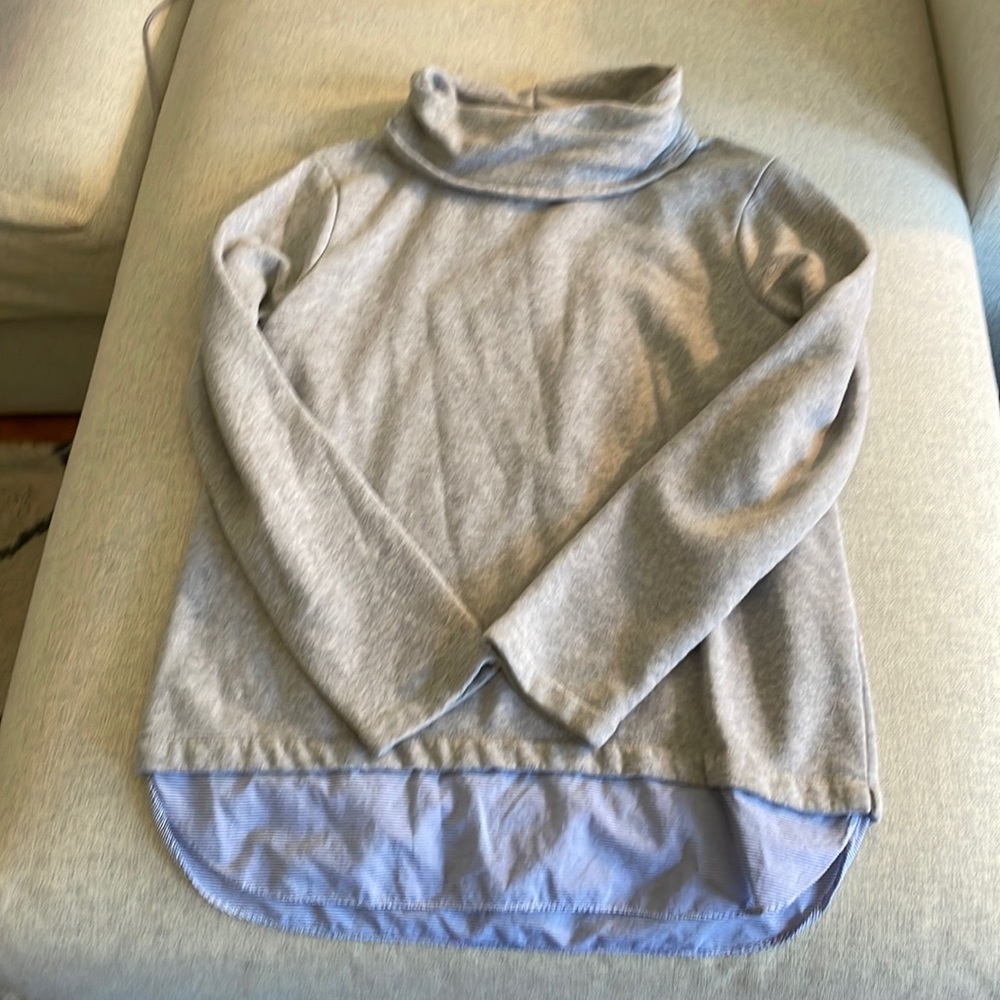 Grey sweatshirt with blue and white detail on bottom